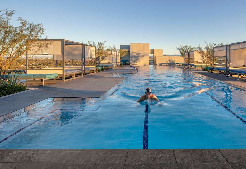 A resident swimming laps in the heated, Olympic length rooftop pool at the Optima Kierland residences in Scottsdale.