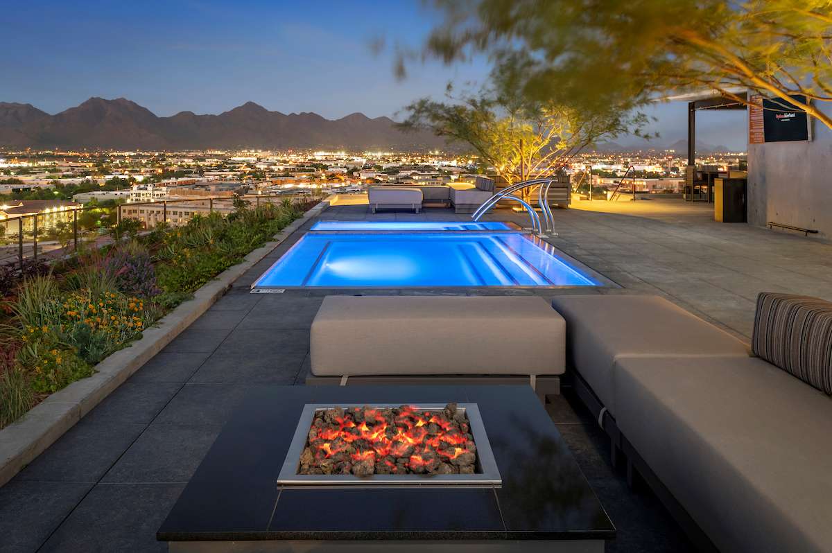 Rooftop sky deck of the Optima Kierland Apartments in Scottsdale, showcasing a resort-style infinity pool & city views.