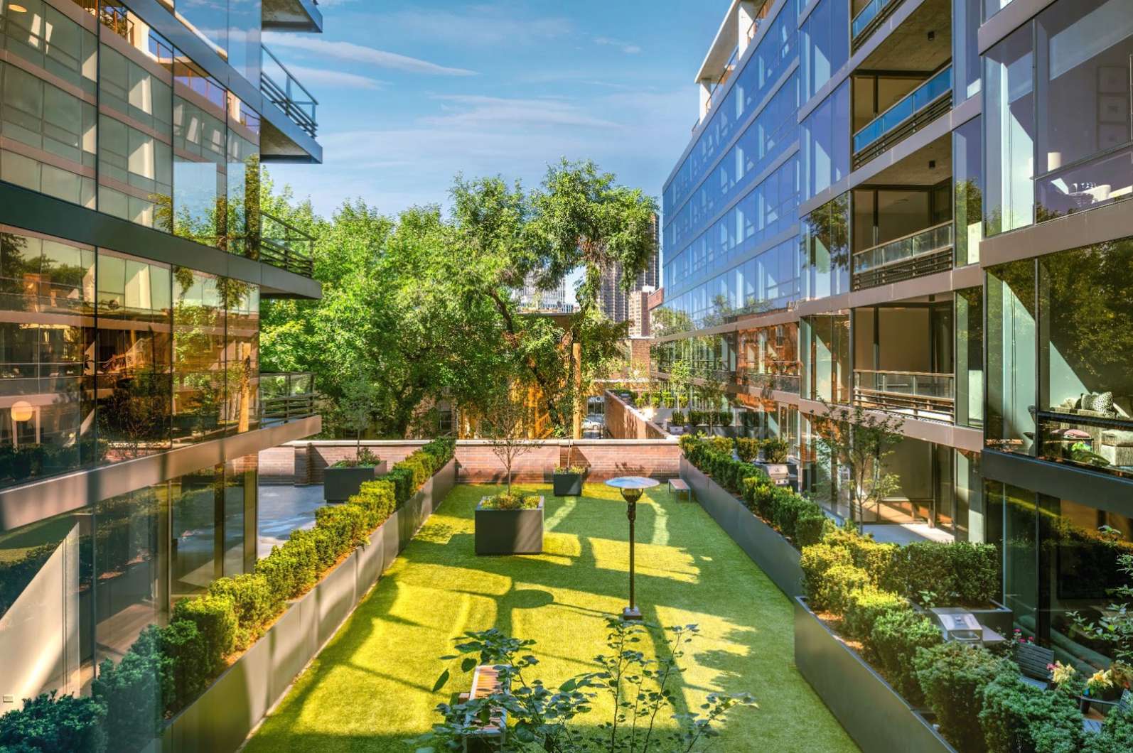Overhead view of the courtyard at Optima Lakeview luxury apartments in Chicago, showing a 2,000 square foot heated dog park.