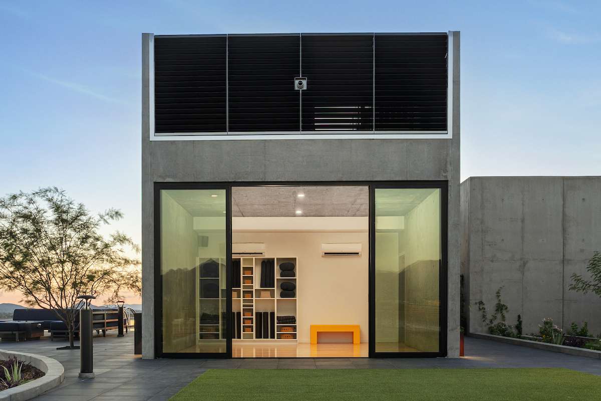 Rooftop yoga studio at Optima McDowell Mountain in Scottsdale, floor-to-ceiling glass walls and concrete construction.