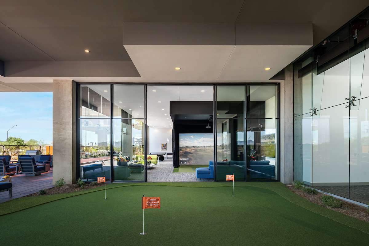 A modern sports lounge and outdoor putting green at Optima McDowell Mountain luxury residences in Scottsdale, Arizona.
