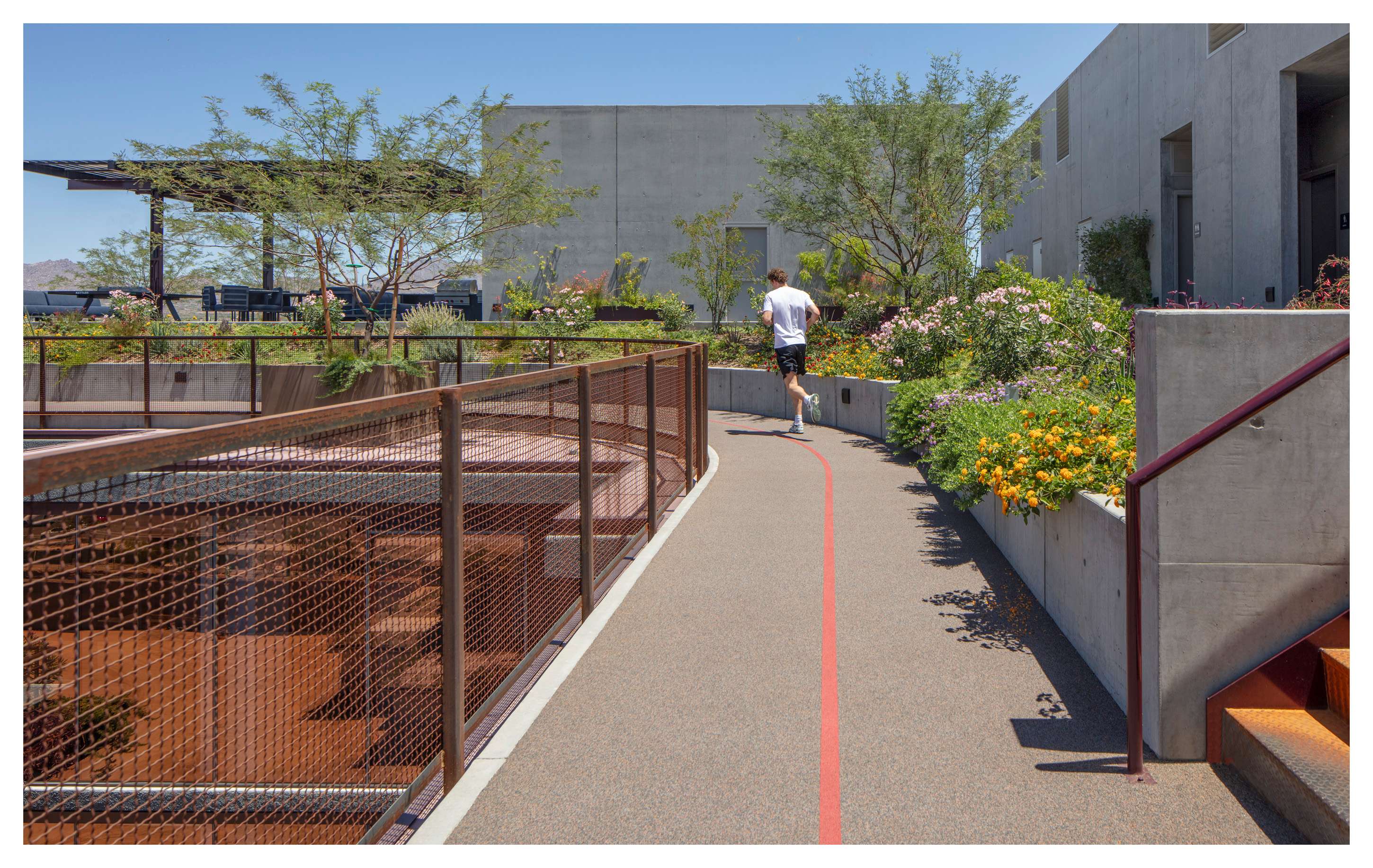 A jogger enjoying the quarter-mile rooftop track at the Optima McDowell Mountain luxury apartments in Scottsdale, Arizona.